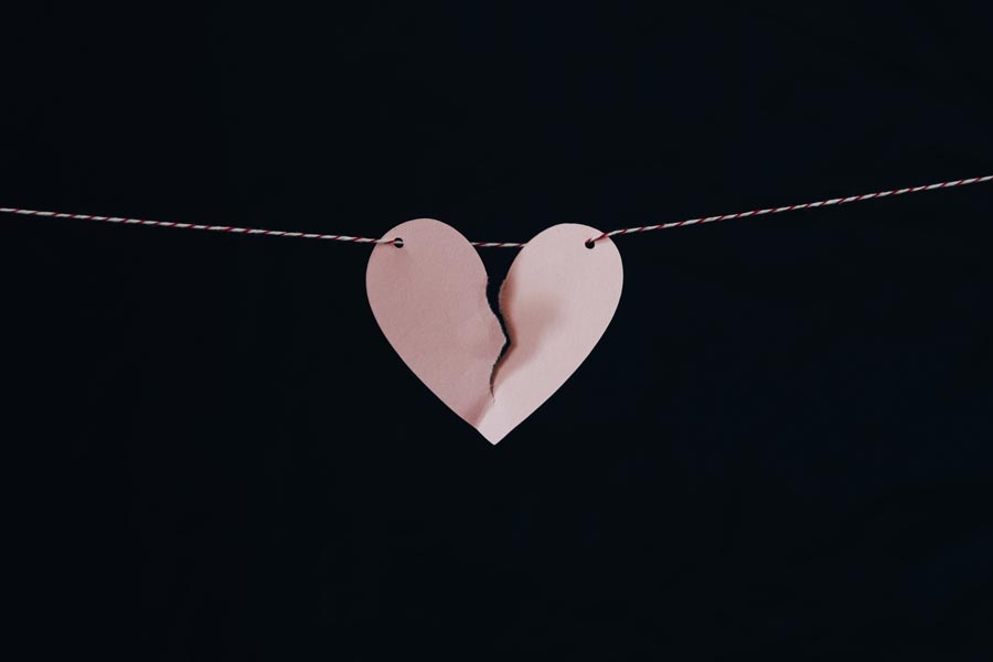 A heart split in two made of cardboard. A striking image representing disappointment for the blog post.